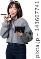 Cheerful asian woman speaking into smartphone with excited expression while holding digital tablet using artificial intelligence assistant isolated on transparency background 143667741