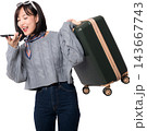 Happy asian woman holding suitcase while using voice artificial intelligence command system on mobile phone for travel trip background 143667743