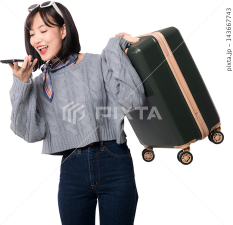 Happy asian woman holding suitcase while using voice artificial intelligence command system on mobile phone for travel trip background 143667743