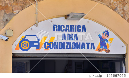 Cefalu, Italy. 21 August 2026. Urban landscape. Sign with the inscription: Ricarica Aria Condizionata. Cefalu, Italy. 21 August 2026. Urban landscape. Sign with the inscription: Ricarica Aria Condizionata. 143667966
