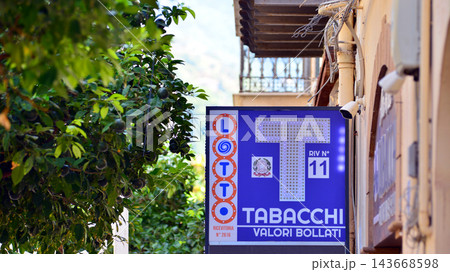 Cefalu, Italy. 21 August 2026. Urban landscape. Neon sign with the inscription: Tabacchi Valori Bollati. Cefalu, Italy. 21 August 2026. Urban landscape. Neon sign with the inscription: Tabacchi Valori Bollati. 143668598