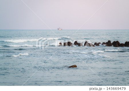 Ocean Waves at Dusk with Distant Fishing Boat in Toucheng, Taiwan Ocean Waves at Dusk with Distant Fishing Boat in Toucheng, Taiwan 143669479