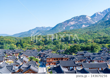 Traditional Korean Hanok Houses and Tiled Roofs against Bukhansan Mountain in Eunpyeong Hanok Village, Seoul Traditional Korean Hanok Houses and Tiled Roofs against Bukhansan Mountain in Eunpyeong Hanok Village, Seoul 143670256