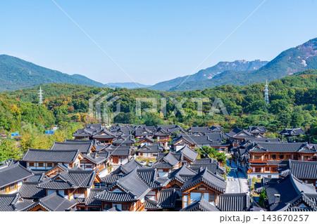 Traditional Korean Hanok Houses and Tiled Roofs against Bukhansan Mountain in Eunpyeong Hanok Village, Seoul Traditional Korean Hanok Houses and Tiled Roofs against Bukhansan Mountain in Eunpyeong Hanok Village, Seoul 143670257