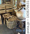 Rustic interior with ceramic vase, woven basket, wooden drawers, stools, and vintage decor arranged together Rustic interior with ceramic vase, woven basket, wooden drawers, stools, and vintage decor arranged together 143670631