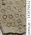 Assorted gold and silver earrings arranged on textured stone surface with open space for copy Assorted gold and silver earrings arranged on textured stone surface with open space for copy 143670632