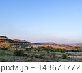 Winding dirt road through rolling hills and open countryside 143671772