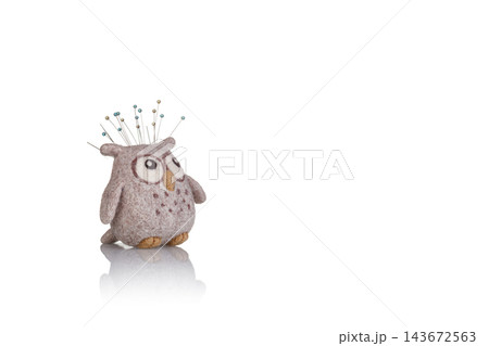 pincushion in the form of an owl on a white background 143672563