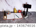 Positive black nutritionist with clipboard creating healthy meal plan for patient at clinic, blank space Stock Photo 143674016