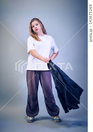 Studio portrait of a girl in casual clothing Studio portrait of a girl in casual clothing 143675269