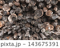 Close-up view of stacked firewood logs showing weathered timber 143675391