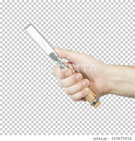 A hand holds a well-used metal putty knife with a wooden handle. A hand holds a well-used metal putty knife with a wooden handle. 143675918