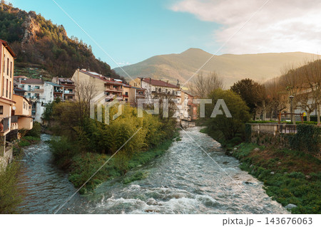Freser river winding through mountain town with golden morning light in Ribes de Fresser Freser river winding through mountain town with golden morning light in Ribes de Fresser 143676063