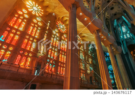 Wall of orange stained glass windows and rose windows inside Sagrada Familia Wall of orange stained glass windows and rose windows inside Sagrada Familia 143676117