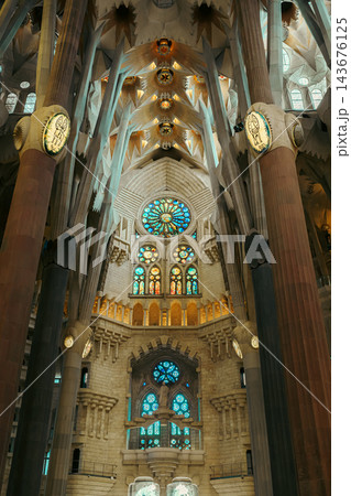 Stained glass rose window and branching columns at the end of the Sagrada Familia nave 143676125