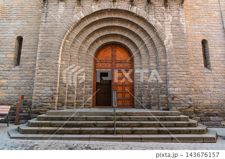 Wooden church door with arched stone portal and stone steps in Ribes de Freser Wooden church door with arched stone portal and stone steps in Ribes de Freser 143676157