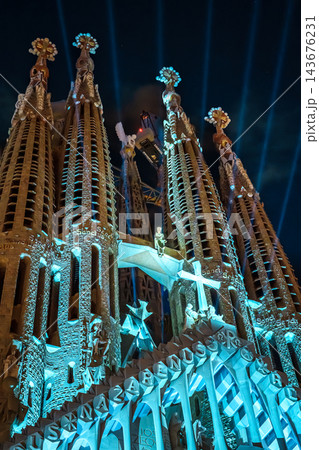 Passion facade sculptures of Sagrada Familia lit at night showing the crucifixion scene 143676231
