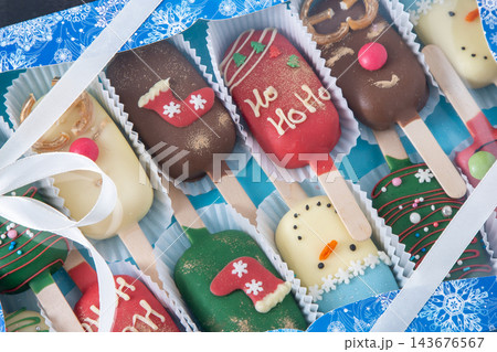 Christmas dessert. Sweet food. Cheesecake stick ice cream. Treat in winter. Candy snowman, deer and Santa Claus. Gingerbread cookies Christmas dessert. Sweet food. Cheesecake stick ice cream. Treat in winter. Candy snowman, deer and Santa Claus. Gingerbread cookies 143676567