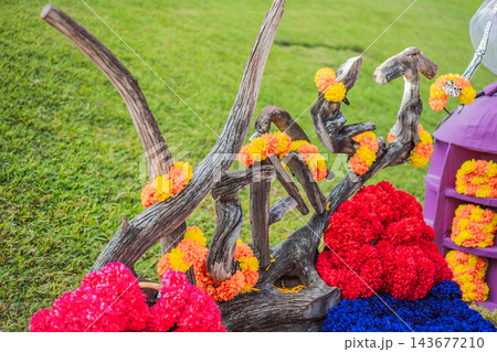 Bright flower clusters and garlands decorating a Mexican festival garden. 143677210