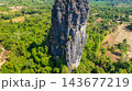 Dramatic Limestone Peaks Over Verdant Countryside in Laos Dramatic Limestone Peaks Over Verdant Countryside in Laos 143677219