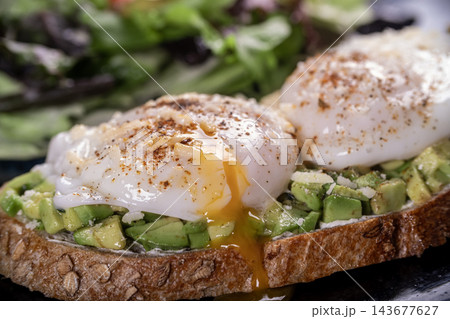 Sourdough Toast with Avocado and Poached Egg. 143677627