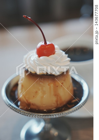 レトロな喫茶店で楽しむ昔ながらのホイップクリームとサクランボがのったプリンとブラックコーヒー レトロな喫茶店で楽しむ昔ながらのホイップクリームとサクランボがのったプリンとブラックコーヒー 143677708