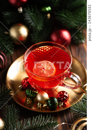 Hot red berry tea with lemon slice festive holiday table setup 143678581