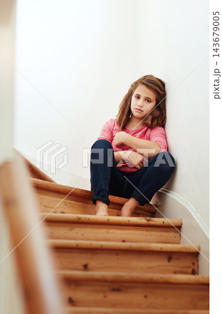 Sad, kid and stairs with portrait upset from family problem, fight and issue while alone. Young girl, waiting and disappointed from fail and parent divorce or orphan on steps and in trouble or grief 143679005
