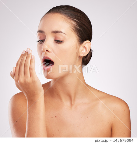 Woman, hand and breath check for hygiene with dental healthcare and oral wellness in studio. Female person, mouth breathing and inspection with smell for teeth or plaque problem by white background 143679094
