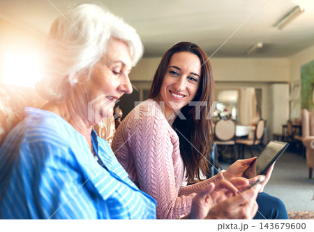 Senior woman, daughter and tablet on sofa for streaming, internet and video call in home living room. Elderly person, child and smile on couch with helping hand for tech savvy, app or communication Senior woman, daughter and tablet on sofa for streaming, internet and video call in home living room. Elderly person, child and smile on couch with helping hand for tech savvy, app or communication 143679600