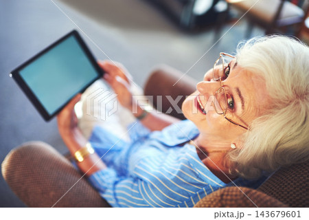 Senior woman, smile and tablet on sofa for streaming, internet and video call in home living room. Elderly person, portrait and tech on couch with helping hand for social media, app or communication Senior woman, smile and tablet on sofa for streaming, internet and video call in home living room. Elderly person, portrait and tech on couch with helping hand for social media, app or communication 143679601