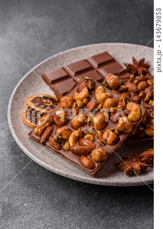 A bar of sugar free milk chocolate with pistachios, almonds, and hazelnuts. A milk chocolate bar A bar of sugar free milk chocolate with pistachios, almonds, and hazelnuts. A milk chocolate bar 143679858