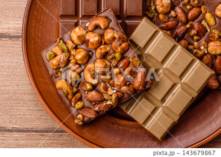 A bar of sugar free milk chocolate with pistachios, almonds, and hazelnuts. A milk chocolate bar A bar of sugar free milk chocolate with pistachios, almonds, and hazelnuts. A milk chocolate bar 143679867