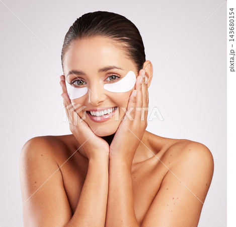 Woman, patches and eye care in studio portrait, facial treatment and hydration mask on white background. Female person, skincare and beauty for moisture, hyaluronic acid and pads for cosmetics glow Woman, patches and eye care in studio portrait, facial treatment and hydration mask on white background. Female person, skincare and beauty for moisture, hyaluronic acid and pads for cosmetics glow 143680154