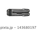 Closed black folding multitool with ruler markings and compact metal handles isolated on a clean white background. 143680197