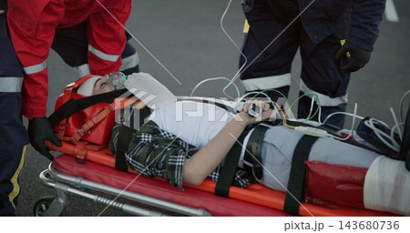 Healthcare, paramedic and help patient in road on scene for emergency, rescue and support. Emt team, people and stretcher for injured person on accident for medical service, care and first aid 143680736