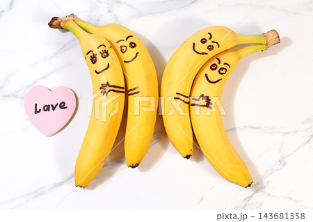 Funny lovestruck bananas hugging each other, featuring cheerful eyes and a little heart with the word love on it. A playful treat for kids and a creative serving idea for parties, birthdays. Funny lovestruck bananas hugging each other, featuring cheerful eyes and a little heart with the word love on it. A playful treat for kids and a creative serving idea for parties, birthdays. 143681358