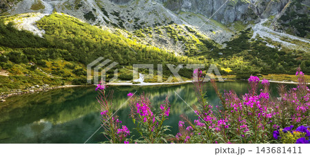 Zielony Staw Kiezmarski mountain lake with clear green water and reflections among rocky slopes of Slovak Tatras. Concept of mountain hiking, pure nature, ecotourism, tranquility, summer travel Zielony Staw Kiezmarski mountain lake with clear green water and reflections among rocky slopes of Slovak Tatras. Concept of mountain hiking, pure nature, ecotourism, tranquility, summer travel 143681411