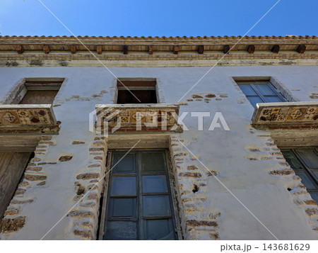 Historic Weathered Building Facade with Decorative Ceramic Tiles Historic Weathered Building Facade with Decorative Ceramic Tiles 143681629