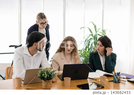 Business professionals collaborating on project planning in office Business professionals collaborating on project planning in office 143682433