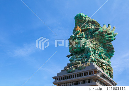 Landscape picture of old Garuda Wisnu Kencana GWK statues as Bali landmark with blue sky as a background. Balinese traditional symbol of hindu religion. Popular travel destinations in Indonesia. Landscape picture of old Garuda Wisnu Kencana GWK statues as Bali landmark with blue sky as a background. Balinese traditional symbol of hindu religion. Popular travel destinations in Indonesia. 143683111