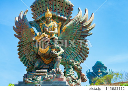 Landscape picture of old Garuda Wisnu Kencana GWK statues as Bali landmark with blue sky as a background. Balinese traditional symbol of hindu religion. Popular travel destinations in Indonesia. Landscape picture of old Garuda Wisnu Kencana GWK statues as Bali landmark with blue sky as a background. Balinese traditional symbol of hindu religion. Popular travel destinations in Indonesia. 143683112