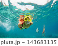 Happy family - active woman in snorkeling mask dive underwater, see tropical fishes in coral reef sea pool. Travel adventure, swimming activity and watersports on summer beach vacation with child. 143683135