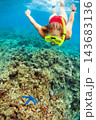 Happy girl in snorkeling mask dive underwater with tropical fishes 143683136