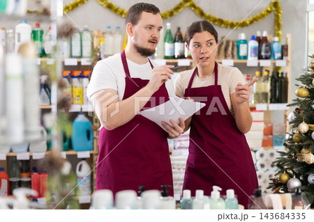 Retail workers discussing inventory results in personal care products store Retail workers discussing inventory results in personal care products store 143684335
