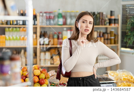 Young woman buyer forgot what she wanted to buy Young woman buyer forgot what she wanted to buy 143684587