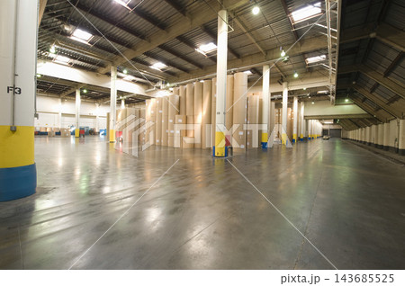Industrial Warehouse Interior with Paper Rolls and Polished Concrete Floor Industrial Warehouse Interior with Paper Rolls and Polished Concrete Floor 143685525