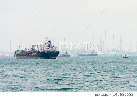 Oil Tanker Ships in Hazy Industrial Harbor Oil Tanker Ships in Hazy Industrial Harbor 143685552