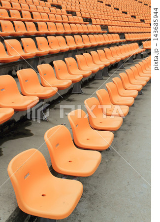 Empty Orange Stadium Seats in Repeating Arena Rows Empty Orange Stadium Seats in Repeating Arena Rows 143685944