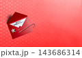 Red Christmas envelope with 'Merry Christmas' note, candy cane, and silver star on red textured background with copy space. Concept of Merry Christmas 143686314